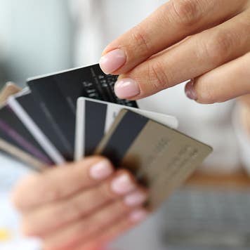 woman holding multiple credit cards