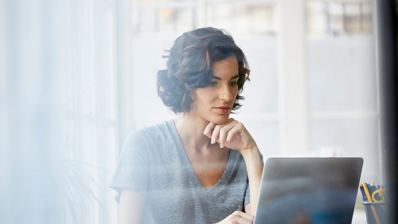 Businesswoman using laptop in office
