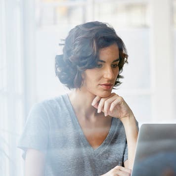 Businesswoman using laptop in office