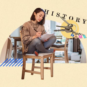 A woman sitting on a chair, reviewing papers