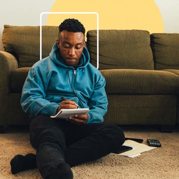 Young person writing on a notepad