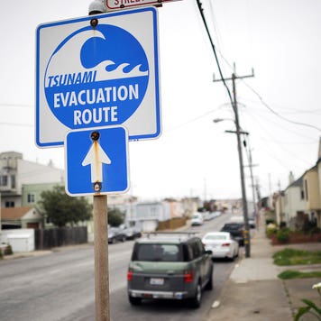 a tsunami evacuation sign on a street