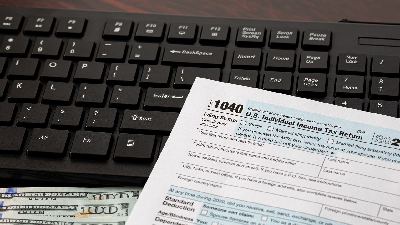Income tax return and computer keyboard. Online filing, tax software and e-file