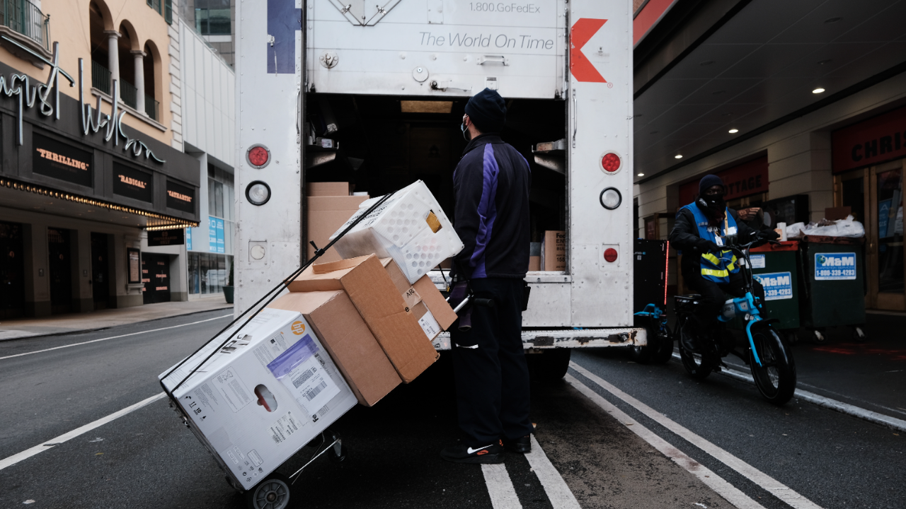 A FedEx truck makes deliveries