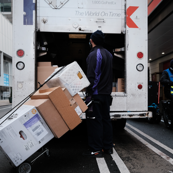 A FedEx truck makes deliveries