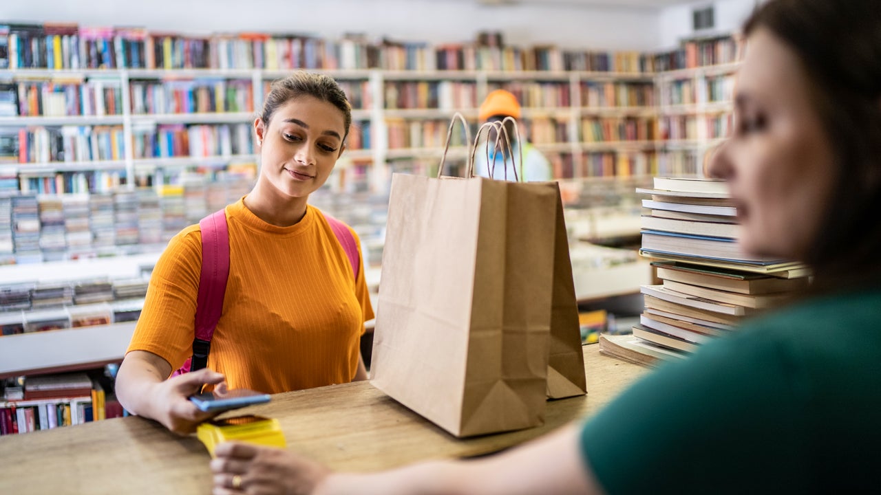 teenager paying for purchase in a store
