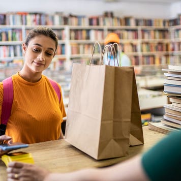 teenager paying for purchase in a store