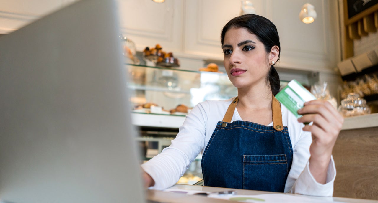 bakery owner making an online purchase with her credit card