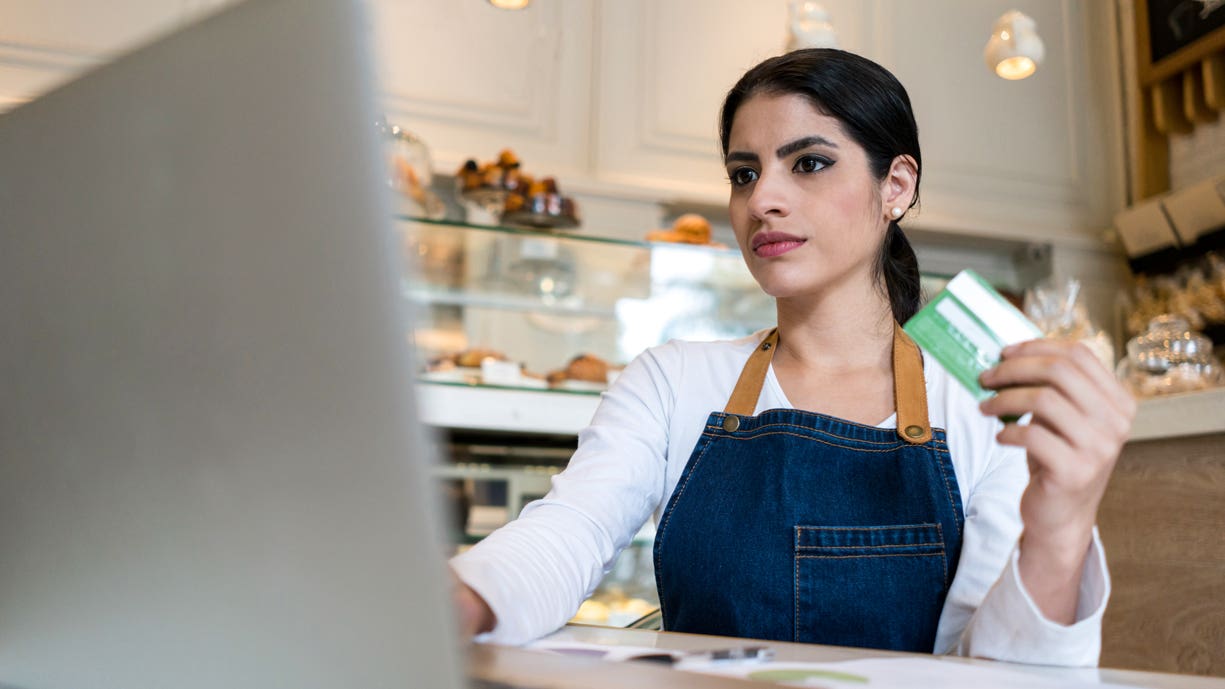 bakery owner making an online purchase with her credit card