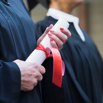 Close-up of hands with a diploma
