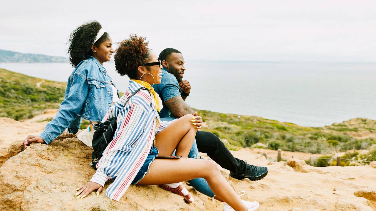 group of friends enjoying the view in a park overlooking the water