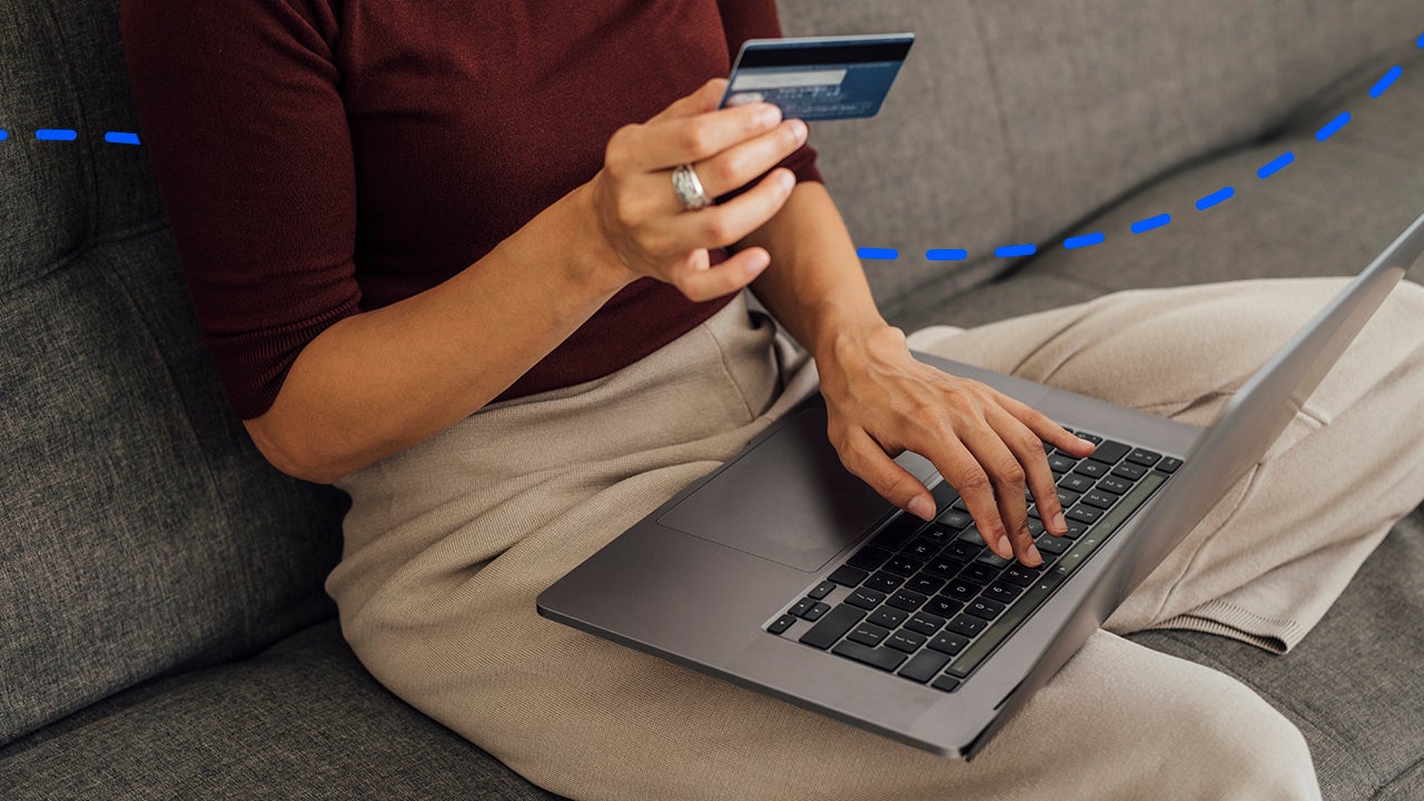 close up of hands paying with a computer