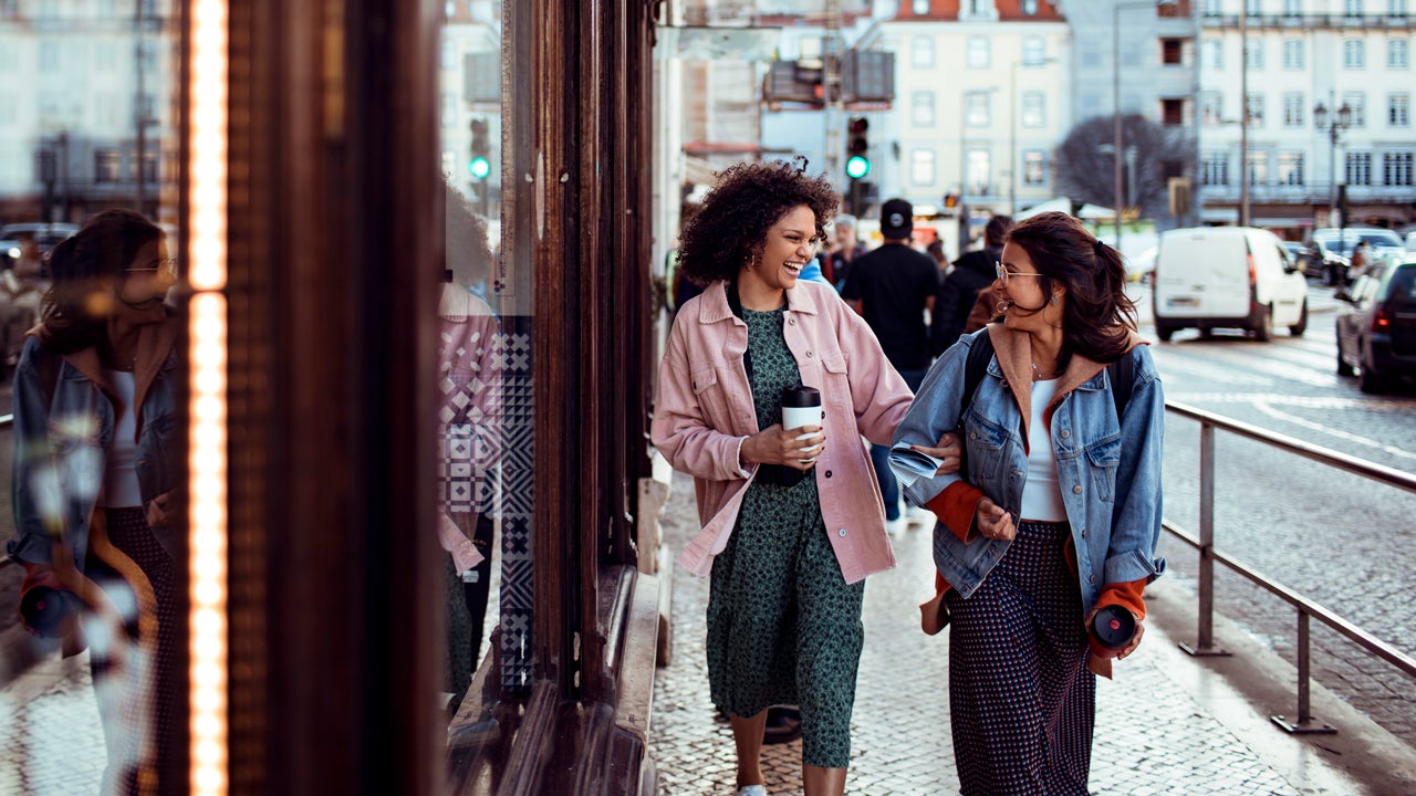 two young women walking in a European city