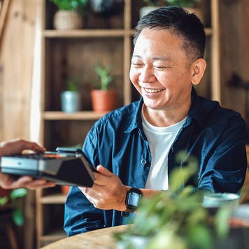 man using contactless payment at restaurant