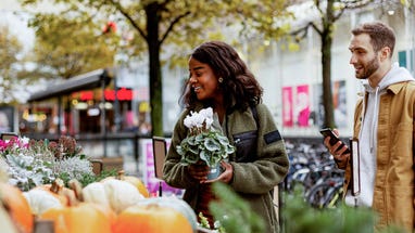 young couple buying flowers
