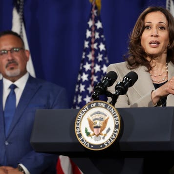 Kamala Harris and Miguel Cardona speak at a podium