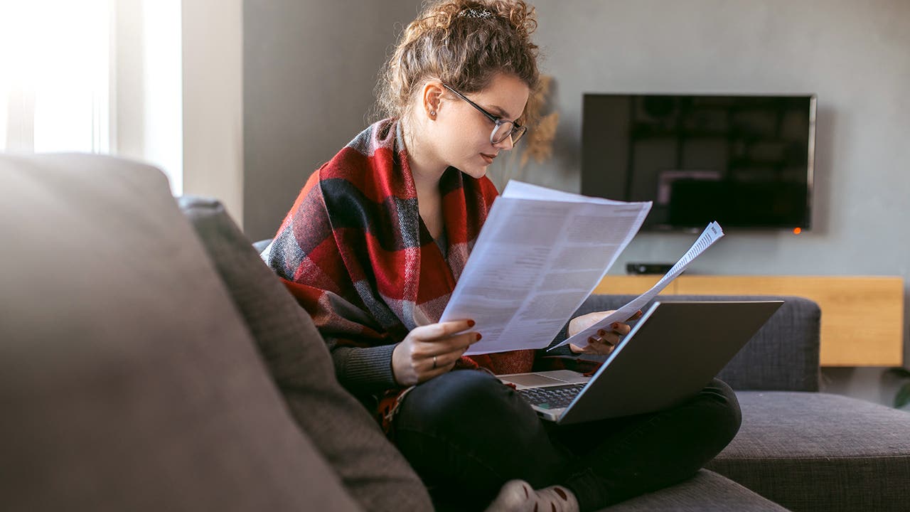 woman looking at paperwork at home