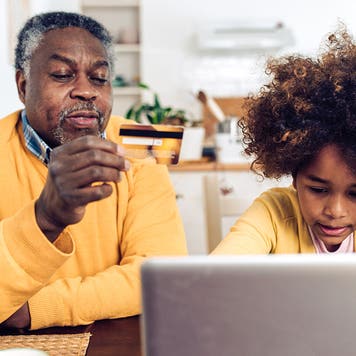 man and his child shopping online at home