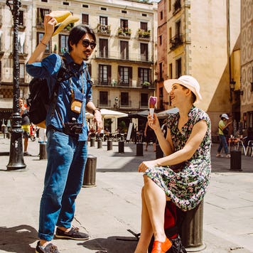 couple relaxing in a city square in Barcelona, Spain