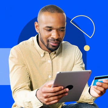 Man using tablet and holding credit card