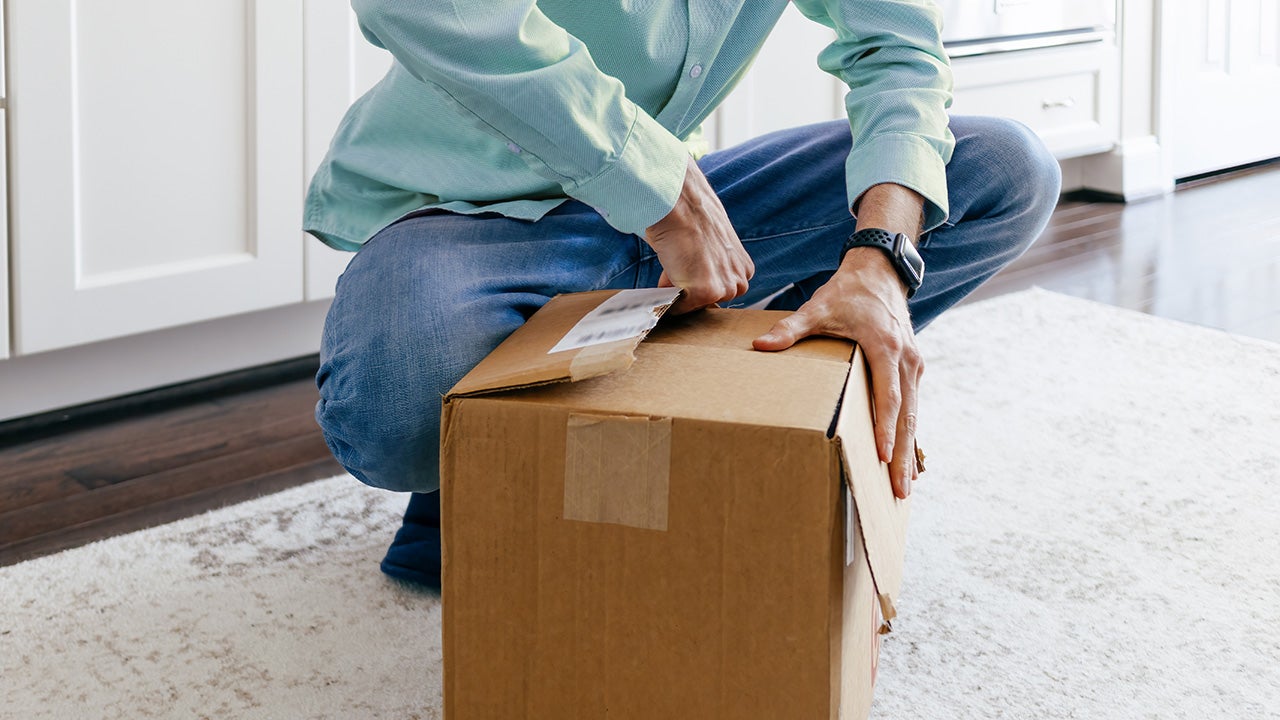 Man Opens Package After Delivery of Online Order