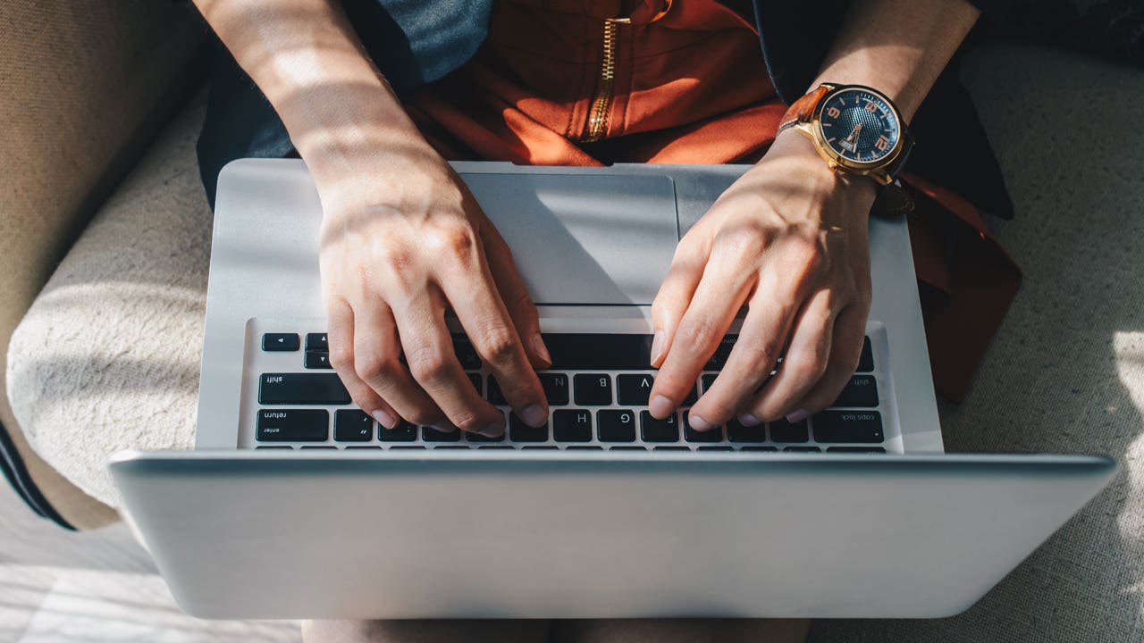 Image of person on laptop from above