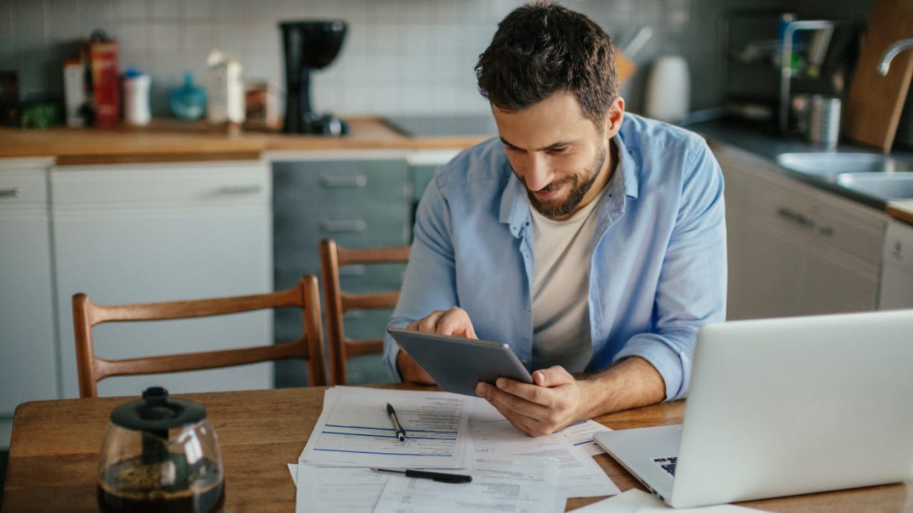 A man calculates his investment returns