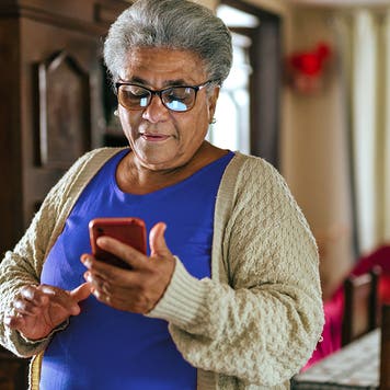 Elderly woman connected to the internet at home