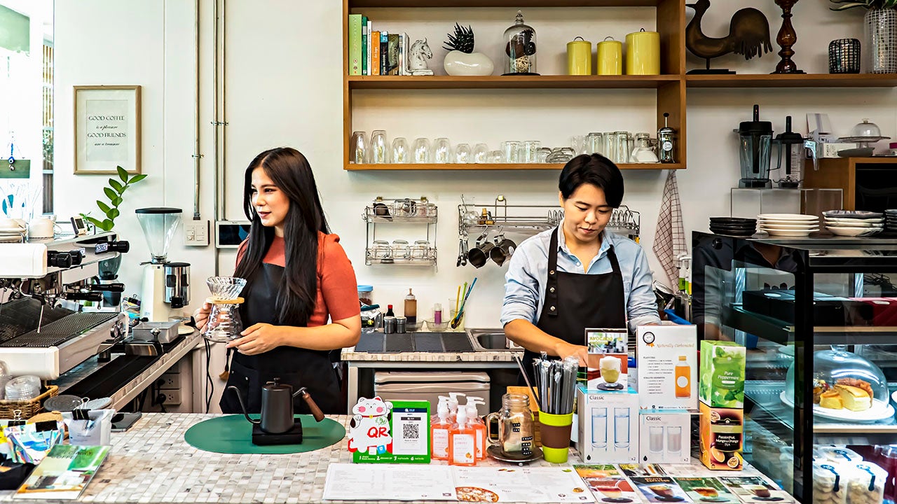 Female owners are working on small business cafe.