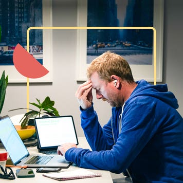 Man looking distressed at laptop