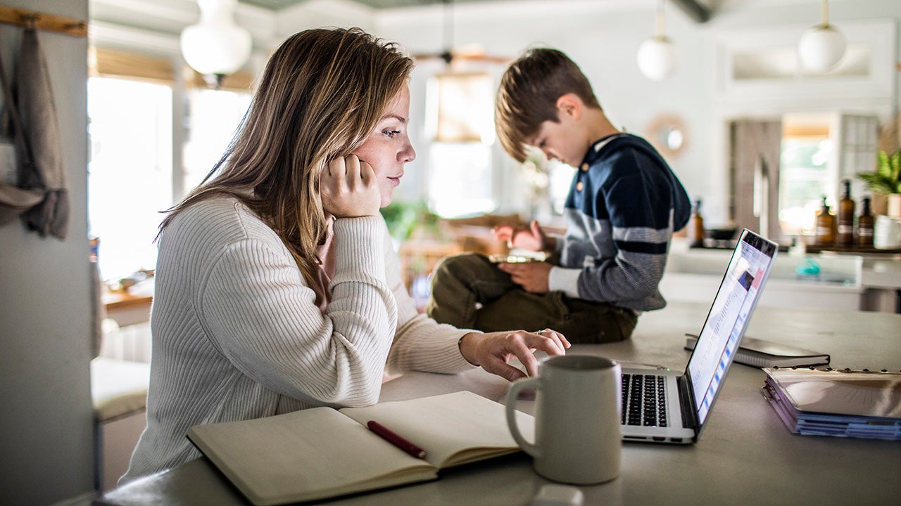 Mom researching on laptop in kitchen