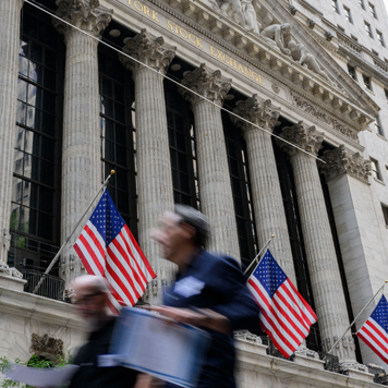 People walk past the New York Stock Exchange