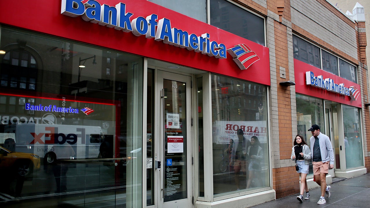 People walk near Bank of America branch, on July 18, 2022 in New York.