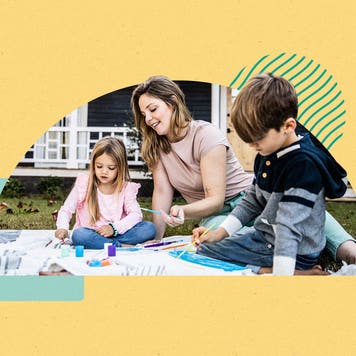 Woman and two children painting outside