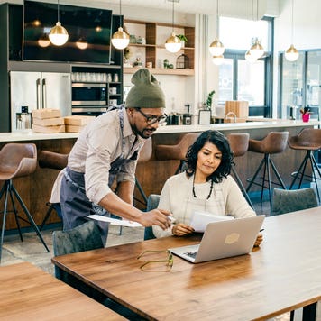 two people looking at computer and discussing business matters in a shop