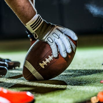 close up shot of a football player about to snap the ball