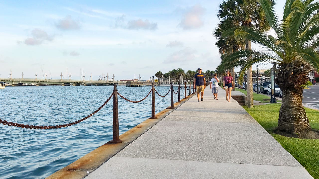 family walking on a path by the water in Florida