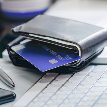 credit card in a wallet sitting on a desk