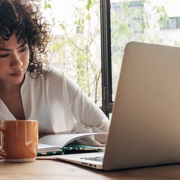woman looking tired at computer