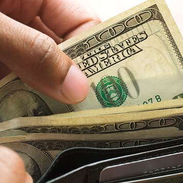 man taking money out of a wallet