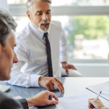 Couple singing paperwork for a loan
