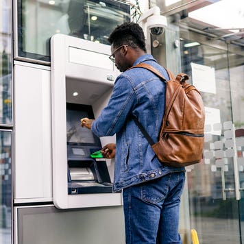 man using an ATM machine