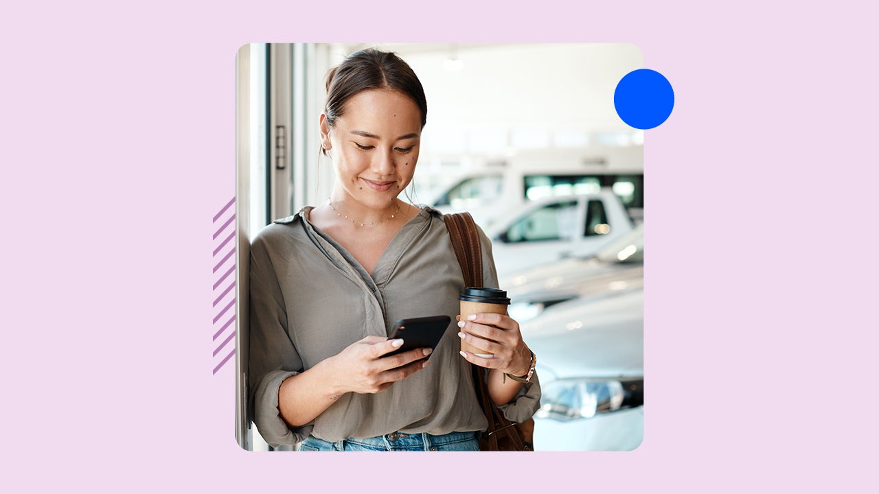 A woman uses her phone while standing in front of a car. The image is on a pink background.