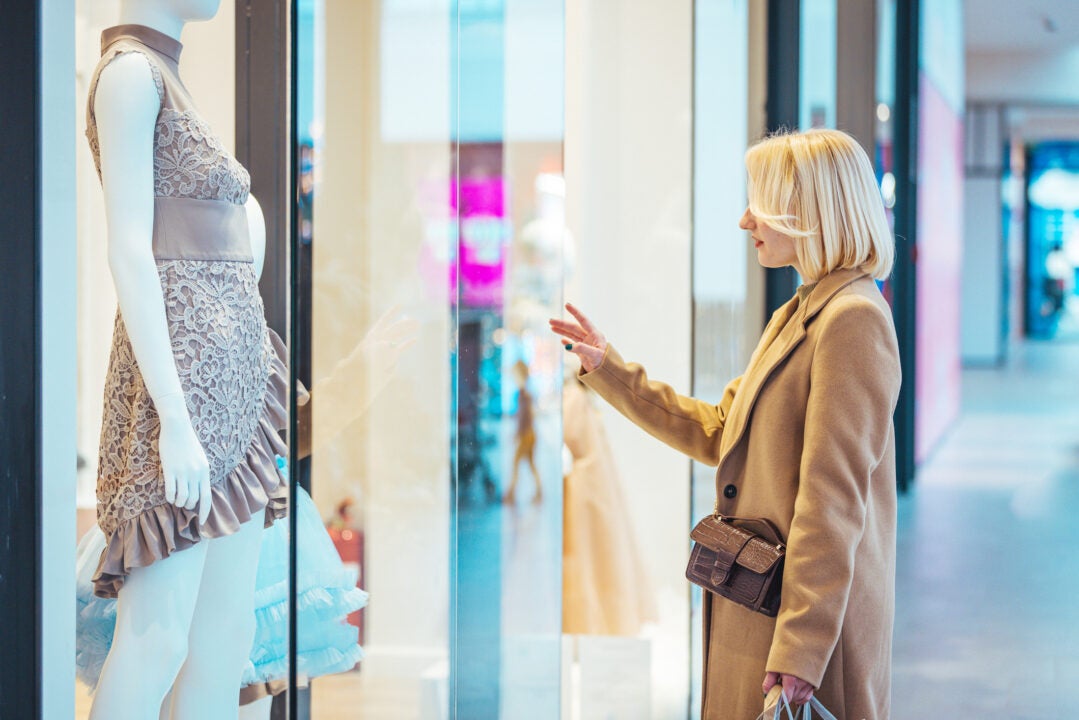 Photo of happy young woman on a shopping pursuit.