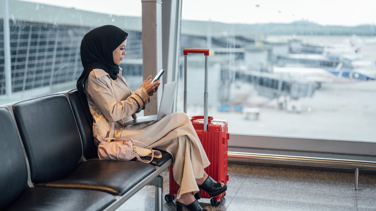 Working and using phone while waiting on departure gate