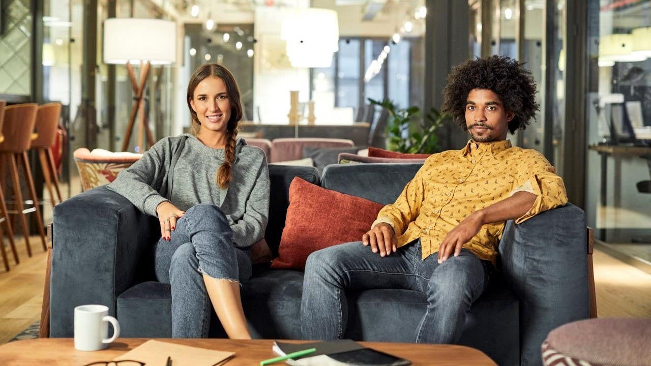 Man and woman sitting on a couch