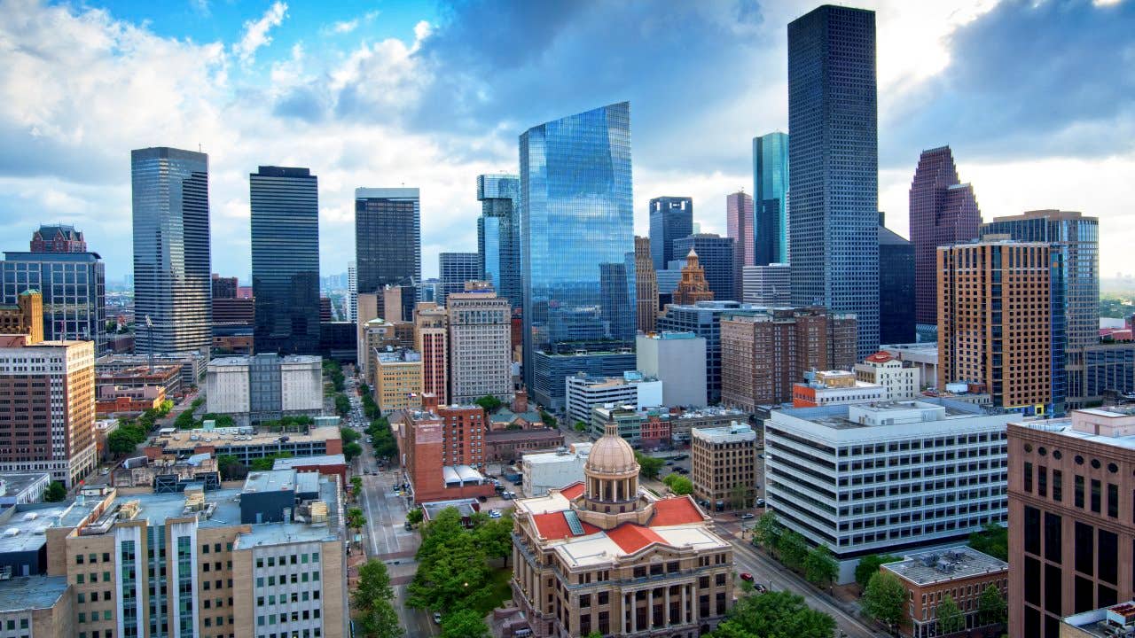 The skyscrapers of downtown Houston rise above the restored neo-classical 1910 Harris County Courthouse in downtown Houston, Texas.