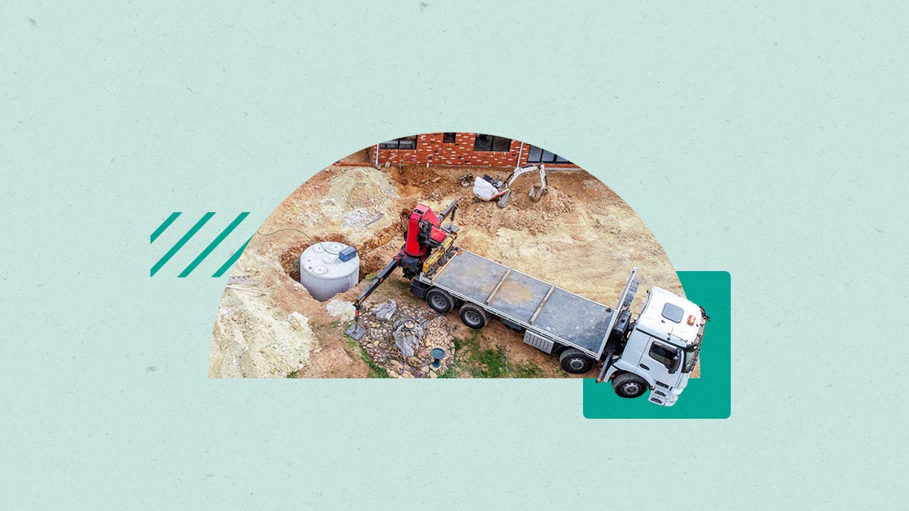 Shot of a flatbed near a septic that has been dug up and is being serviced.