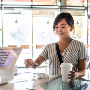 Woman pays with credit card at checkout