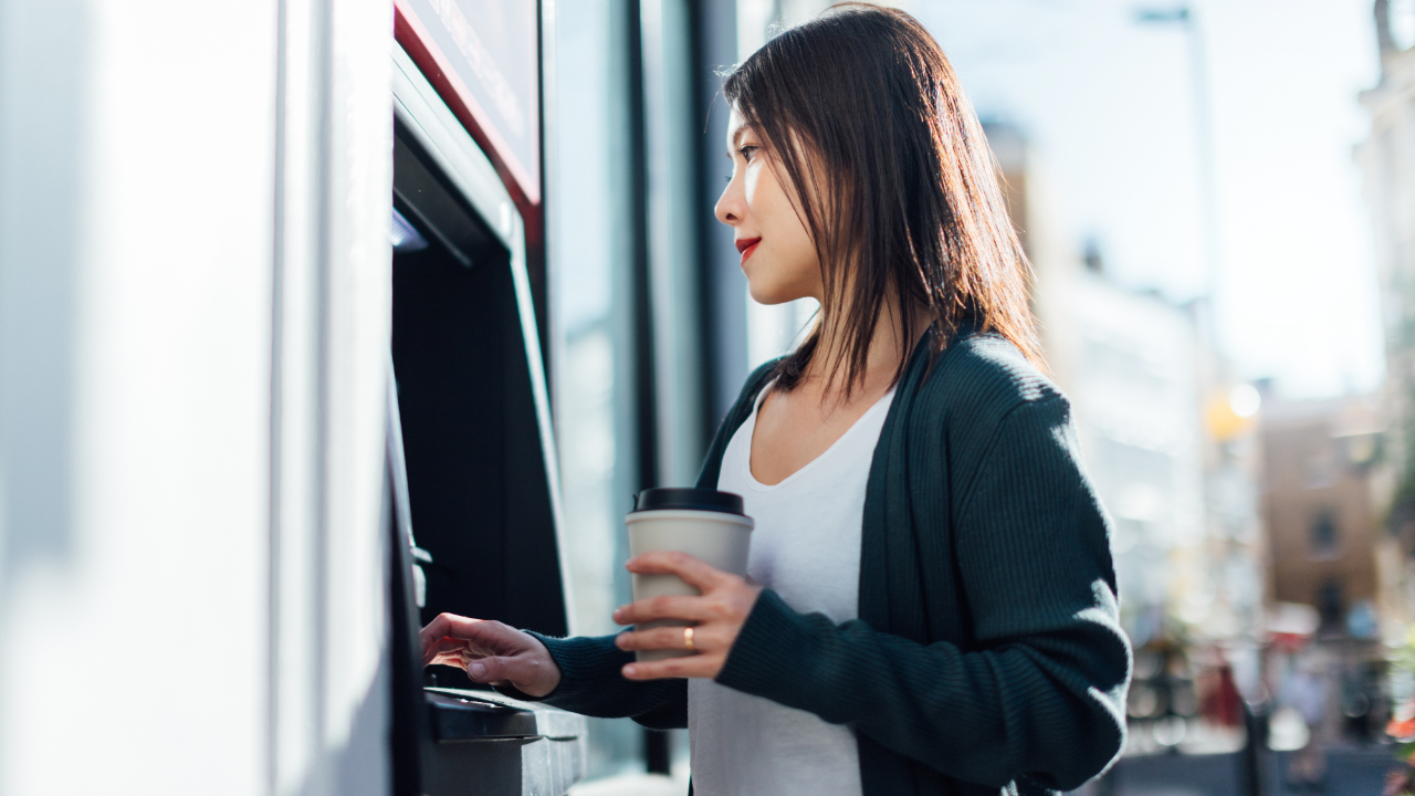 Woman getting money out of an ATM